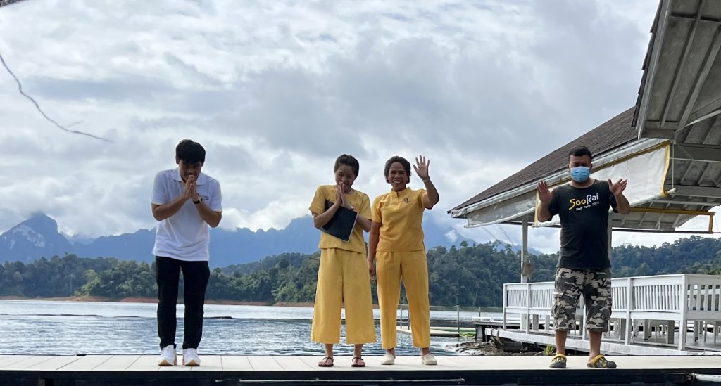 Staff waving bye at 500 Rai Floating Resort
